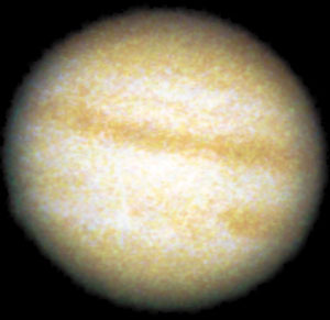 Jupiter
Mulitple negative images were added together to form the single picture. Processed in Photoshop? using ?calculation? of the individual channels in CMYK, one channel at a time.

Note that on the limb is the moon Io. Normally the moons of Jupiter are too faint to be recorded at the same time as Jupiter itself. However, when the large gallilean moons pass in front of Jupiter's disk it is possible to steal a little of Jupiter's light in order to bring out the tiny moon.
Link-words: Jupiter