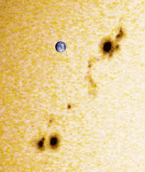 Sunspots!
Ray Hemming captured this wonderful picture of a sunspot group on the Sun's surface on 10 May 2001. 
He simply pointed a digital camera up to the eyepiece a clicked! 
An image of the Earth at the same scale has been superimposed on the picture to show how large these solar features are.
Link-words: Sun