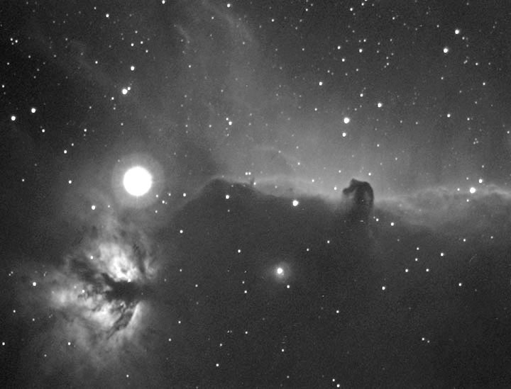The Horsehead Nebula in Orion.
The Horsehead is a dark nebula, also known as Barnard 33. It is in front of IC 434, which is a light nebula.The Horsehead is 1,500 ly away & is 3.5 ly across.
It is made up of thick dust, & the red glow behind it is hydrogen gas which is ionized by Sigma Orionis.  
Link-words: Nebula