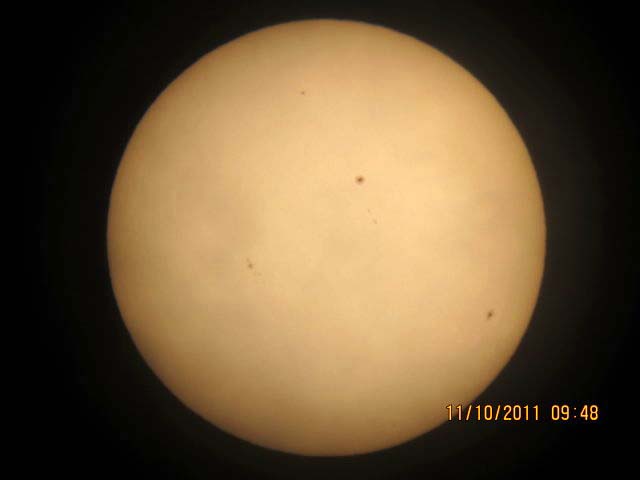 The Sun by Ken Pearson - October 2011 
ETX90E telescope and my new Canon IXUS115HS digital camera. The camera has 12.1 Mega Pixels and the original file sizes were 9Mbits each. There was a thin vale of high cloud so the images are not pin sharp. Even so there are at least nine or more sun spots visible. It looks like solar maximum has arrived at last
