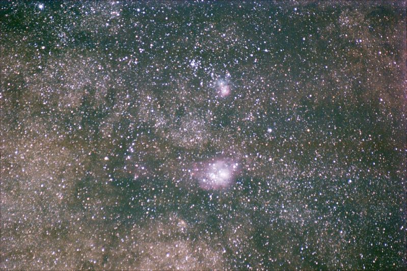 M8 Lagoon, M20 Triffid and M21 Cluster in Sagittarius
A narrower widefield of the area around these objects.
The image was captured with the older Canon 55-200mm f4.5/5.6 zoom lens operating at 200mm F5.6.  The lens is really not up to the job, 4mm play in the lens assembly when racked out for 200mm has affected the image badly.

Capture details: 20 x 300s ISO 800 Canon EF55-200mm F/4.5-5.6 II USM 200m@f/5.6
Link-words: Star Messier Nebula
