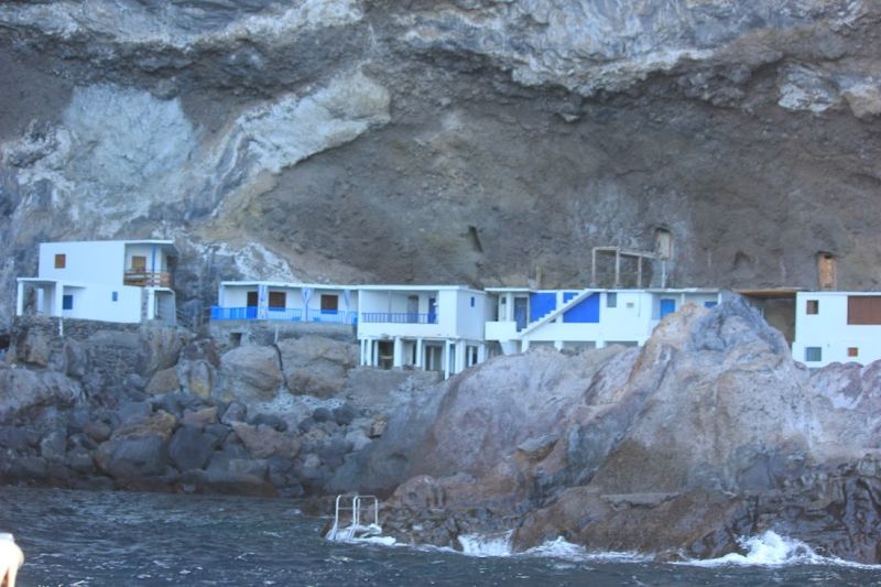 Whales and Dolphins trip
Cruising past some holiday homes at front of a cave - west coast of island - they can be rented- but it looks quite precarious to get there walking down steep coastal paths
Link-words: LaPalma2024