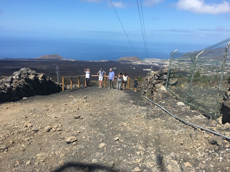 Lava spread across villages and farms 
Below the 2021 eruption 
In 2021 More than 7,000 people had to leave their homes. Over 1,300 homes were destroyed by the lava flow. Our guide was one of those who had to leave their home.  No-one died. 
Many other buildings, such as churches and schools, were damaged or destroyed. 
Hundreds of acres of farmland, including banana plantations, were destroyed. 
  
The Army helped re-house victims and the government paid compensation to those who lost homes and businesses. 

Link-words: LaPalma2024